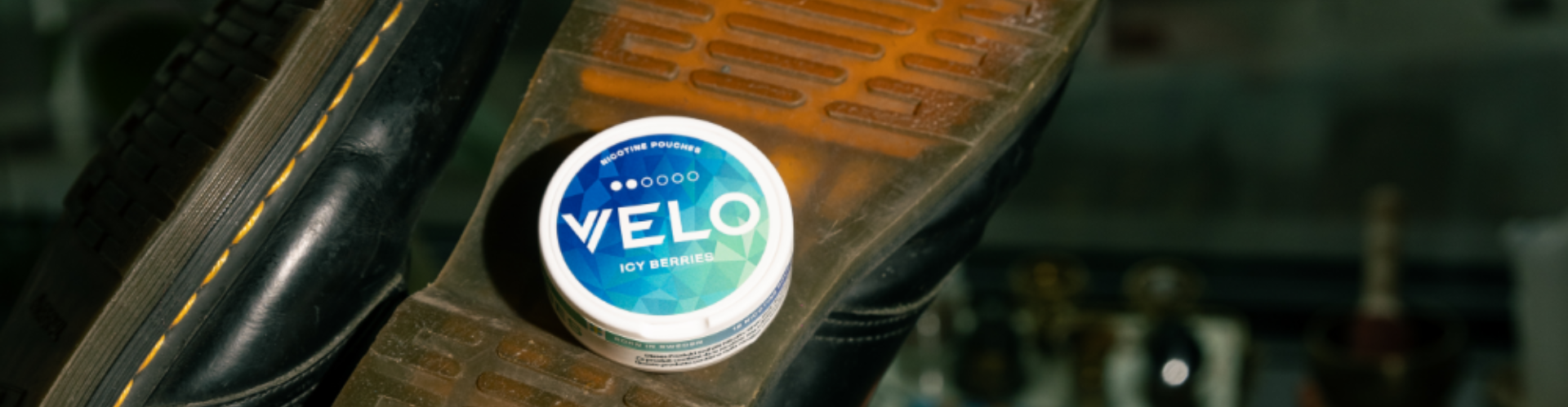 A person opens a box of nicotine pouches VELO