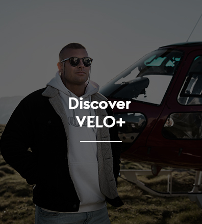 Velo influencer on a beach with a helicopter