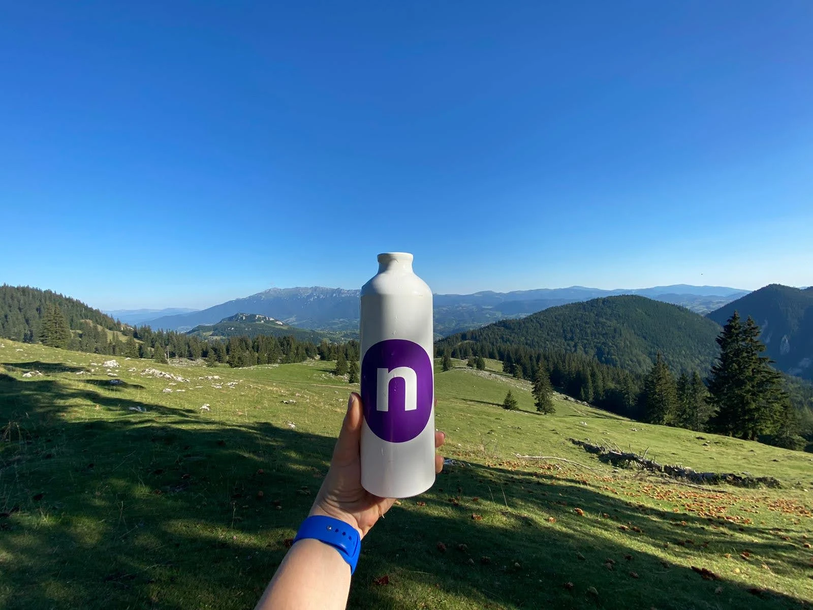 Netcentric bottle is held at the green mountain tops